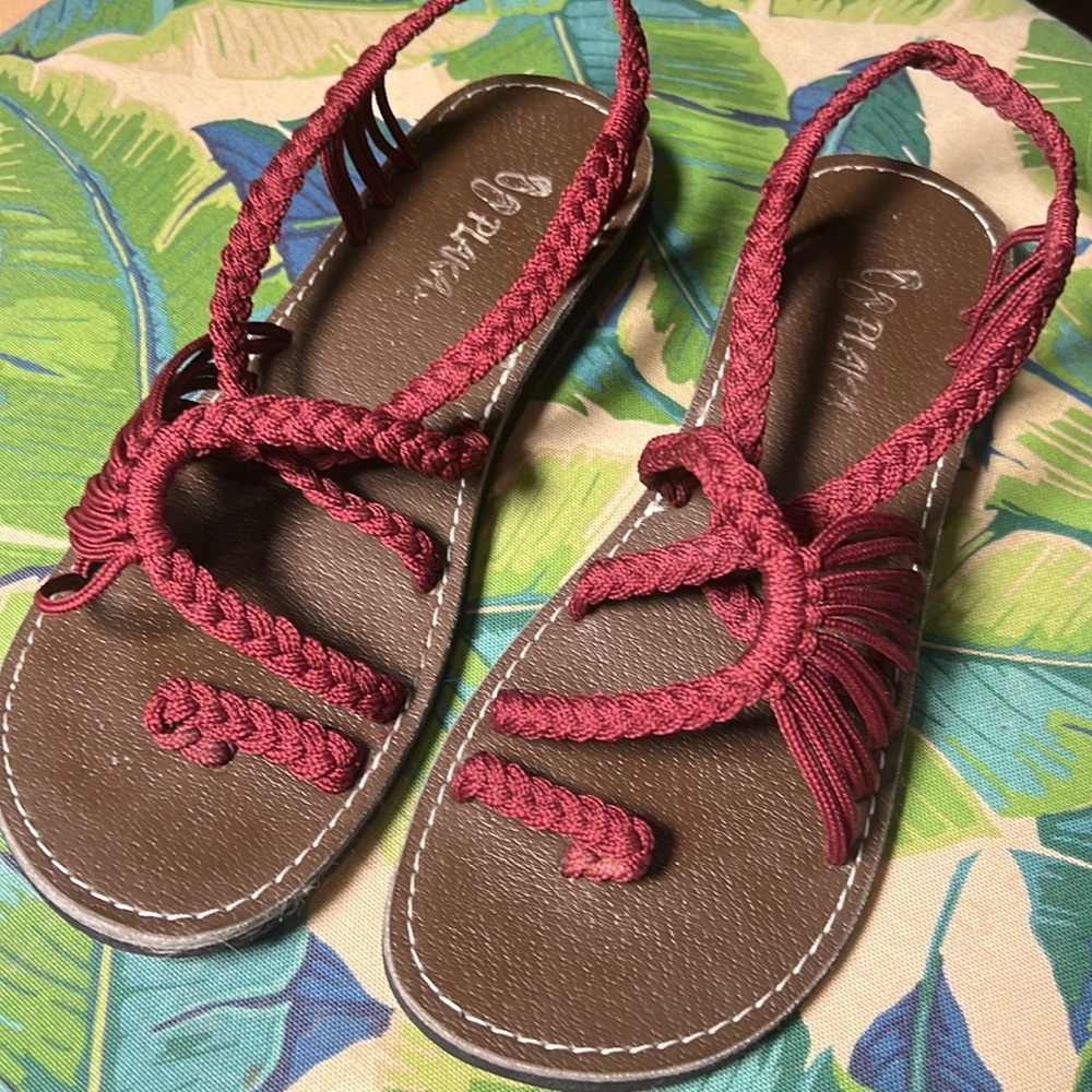 Maroon strappy sandals with woven fabric.